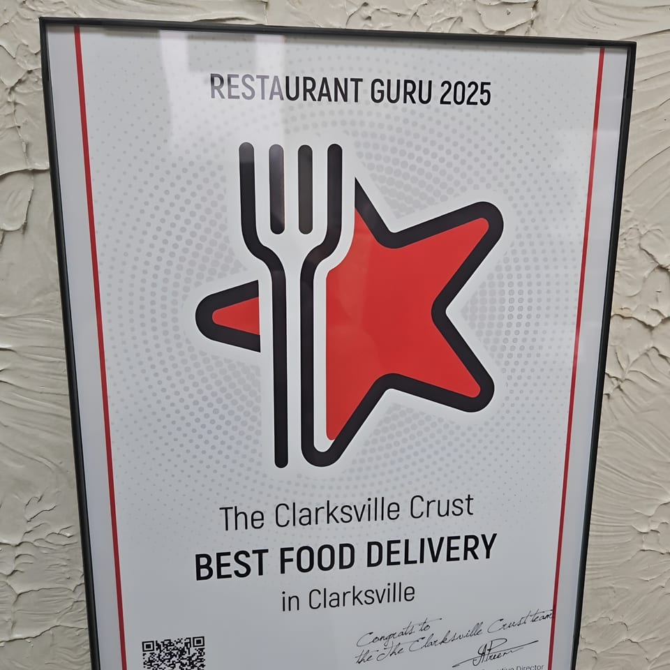 A framed "Restaurant Guru 2025 Best Food Delivery" award for The Clarksville Crust.
